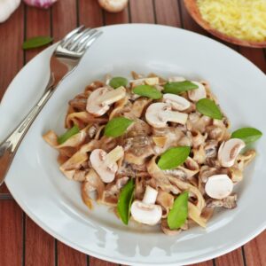 pasta with mushroom with leaves on plate