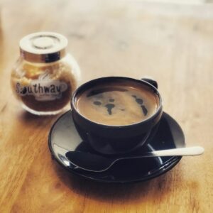 black ceramic teacup with saucer close-up photography